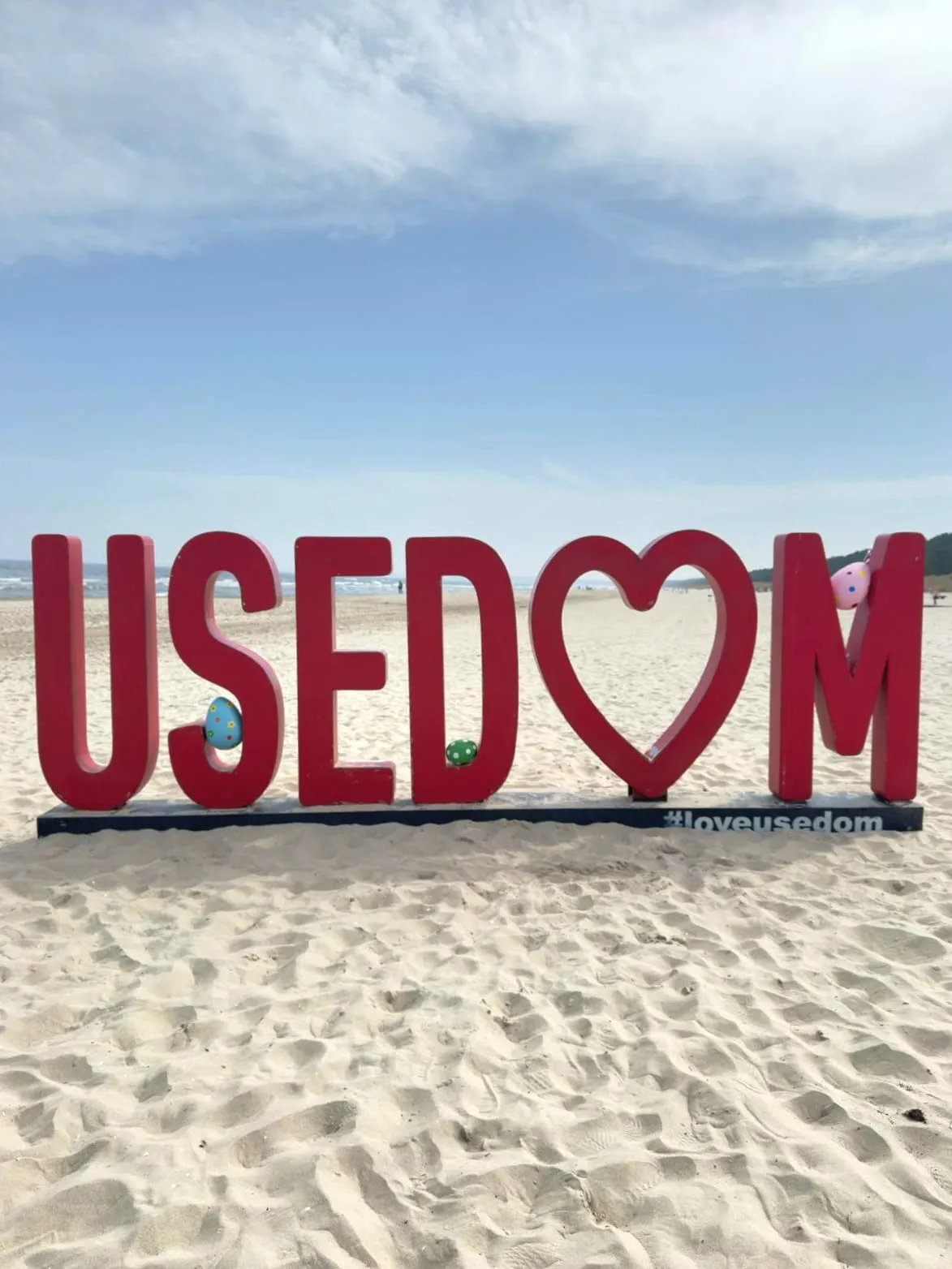 USEDOM lettering with Easter eggs on the beach